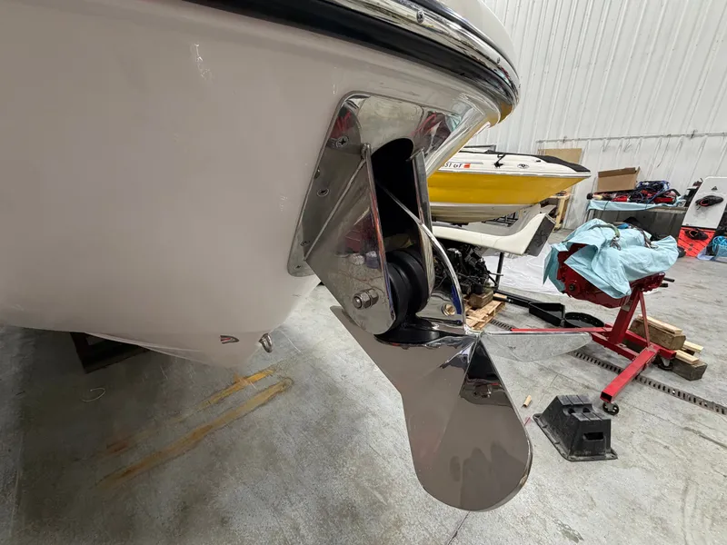 Slide: The Image of 2026 Sea Ray SDX 270 boat hull with propeller in storage facility. - 10