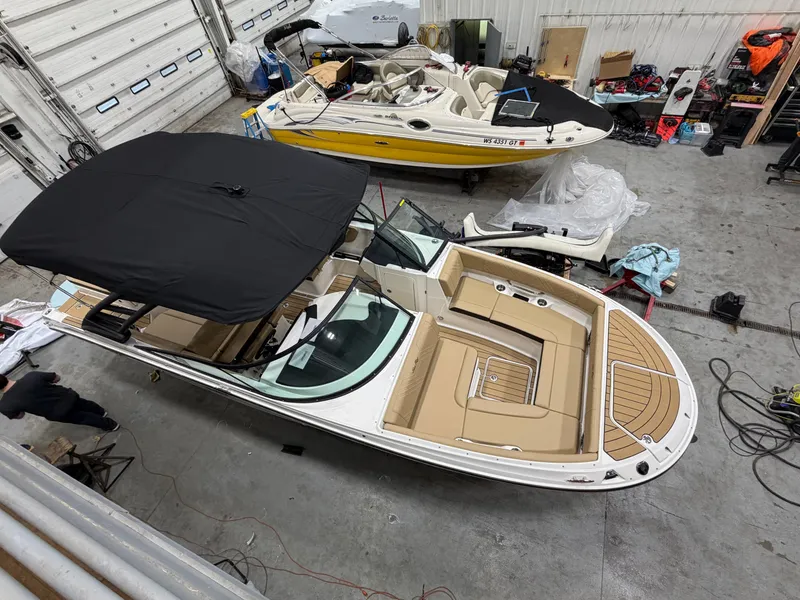 Slide: The Image of 2026 Sea Ray SDX 270 boat in a workshop. - 16