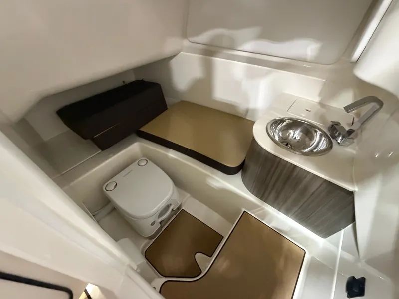 Slide: The Image of Interior of 2026 Sea Ray SDX 270 with toilet and sink. - 32