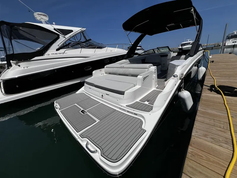 Slide: The Image of 2026 Sea Ray SDX 290 at dock with gray deck and black sunshade. - 15