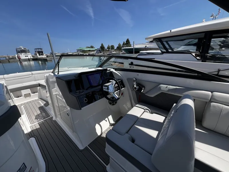 Slide: The Image of The image shows the cockpit of a 2026 Sea Ray SDX 290 boat with modern instruments and gray upholstery. - 19