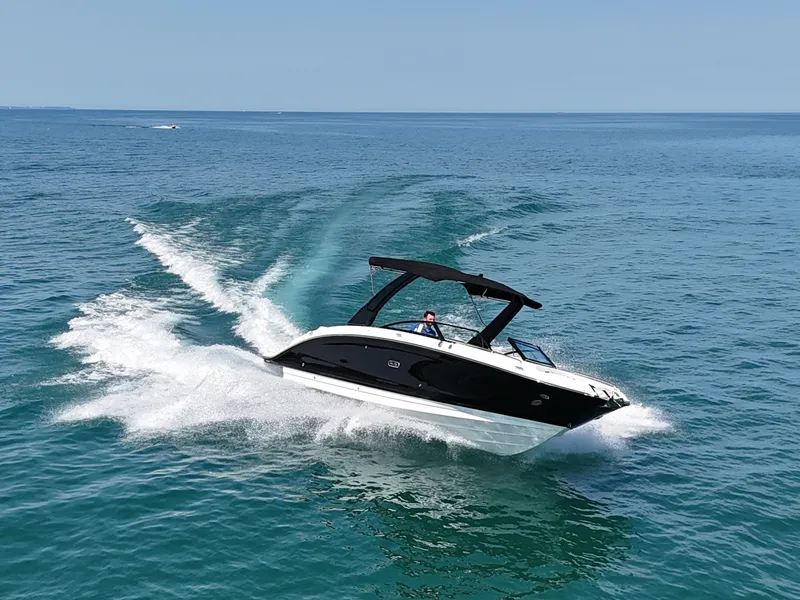 Slide: The Image of A 2026 Sea Ray SDX 290 speeding across the blue water. - 0
