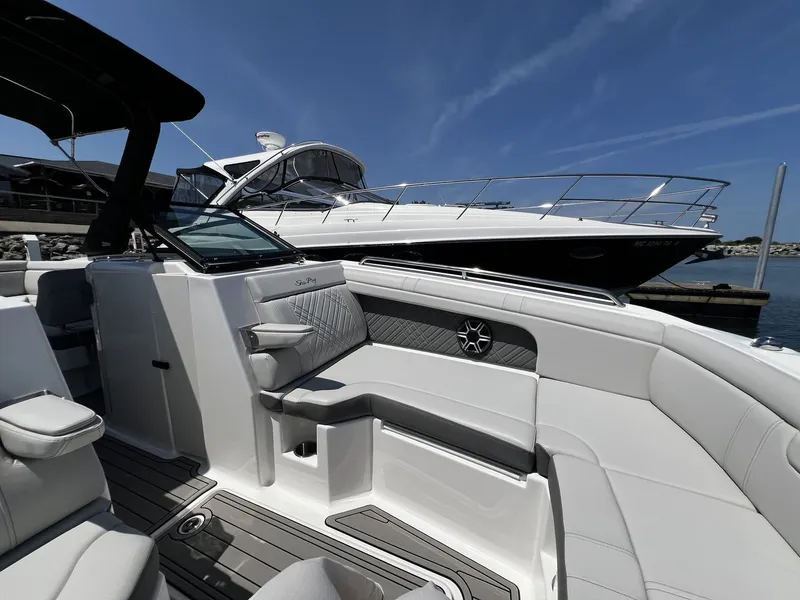Slide: The Image of The image shows the luxurious interior of a 2026 Sea Ray SDX 290 boat with elegant seating. - 22