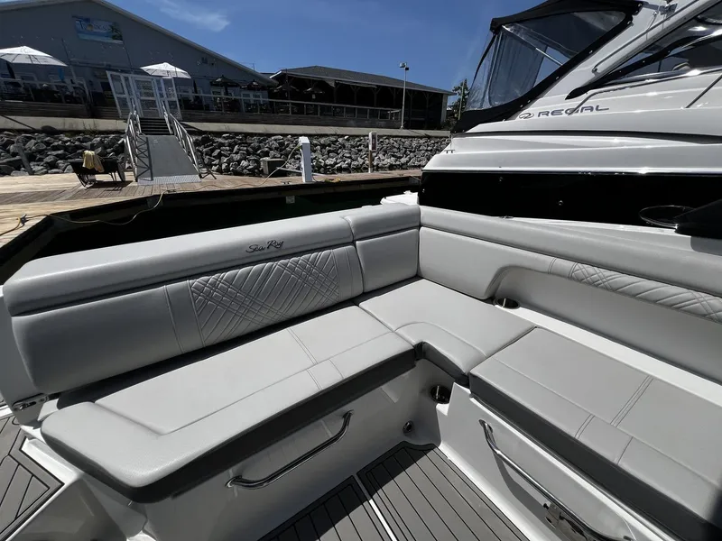 Slide: The Image of The image shows the elegant, upholstered seating area of a Sea Ray SDX 290 boat. - 13