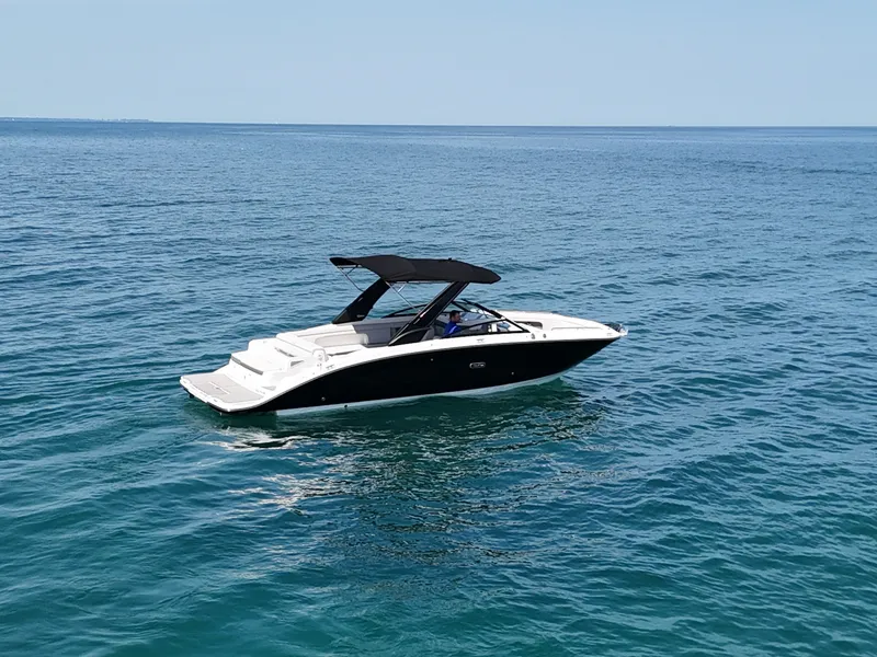 Slide: The Image of A 2026 Sea Ray SDX 290 cruising on calm waters with a black canopy. - 4