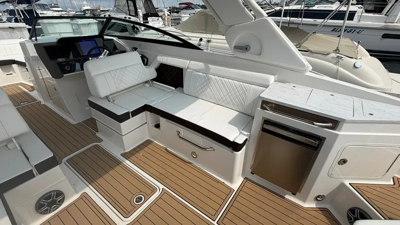 Slide: The Image of The image shows the cockpit of a 2026 Sea Ray SDX 290 with sleek seating and a refrigerator. - 14
