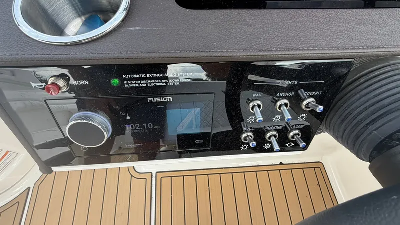 Slide: The Image of Dashboard of the Sea Ray SDX 290 with Fusion stereo system and switches. - 22