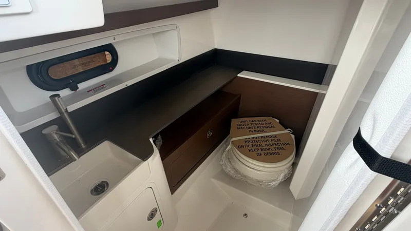 Slide: The Image of Interior of a 2026 Sea Ray SDX 290 with a sink and storage area. - 26
