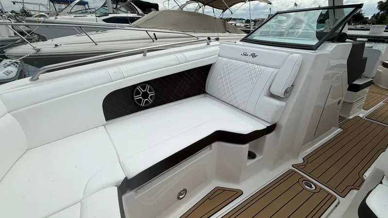 Slide: The Image of The image shows the cockpit of a Sea Ray SDX 290 boat with sleek white upholstery. - 30