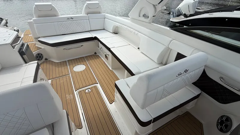 Slide: The Image of The image shows the spacious cockpit of a Sea Ray SDX 290 with elegant white seating. - 18