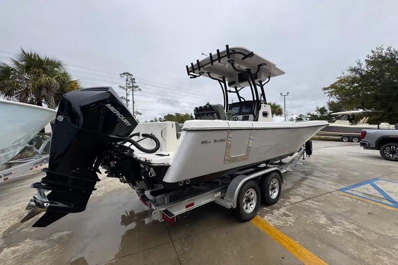 Slide: The Image of 2026 Sea Born LX26 Center Console boat on trailer, featuring a powerful Mercury outboard engine. - 11