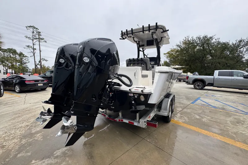 Slide: The Image of 2026 Sea Born LX26 Center Console boat on trailer with dual outboard engines. - 12