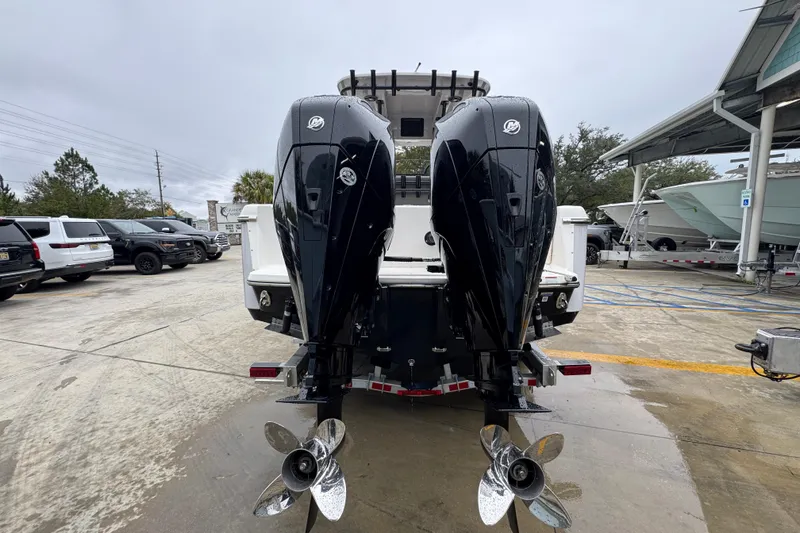 Slide: The Image of 2026 Sea Born LX26 Center Console with dual outboard motors in a marina setting. - 13
