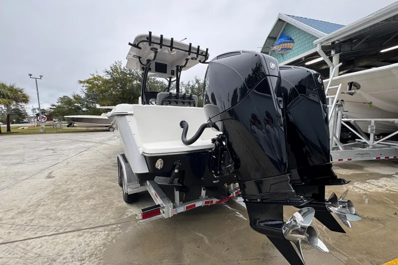 Slide: The Image of 2026 Sea Born LX26 Center Console boat with dual outboard engines on a trailer. - 14