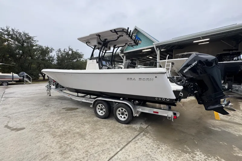 Slide: The Image of 2026 Sea Born LX26 Center Console boat on trailer, parked outdoors. - 16
