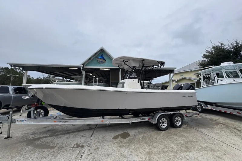 Slide: The Image of 2026 Sea Born LX26 Center Console boat on trailer at dealership. - 2