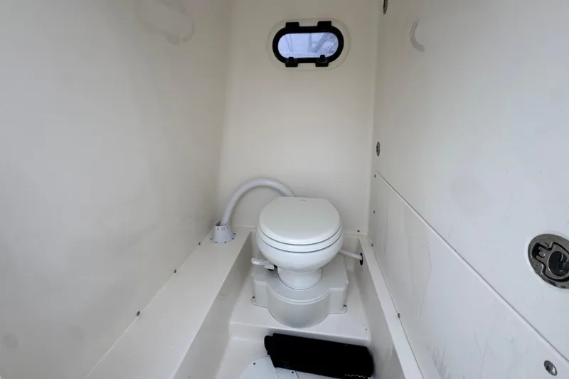Slide: The Image of 2026 Sea Born LX26 Center Console boat interior with compact marine toilet. - 25