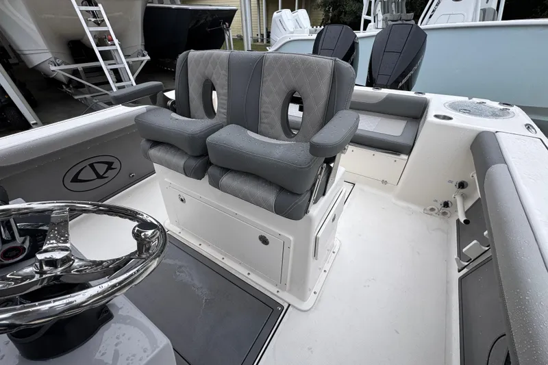 Slide: The Image of 2026 Sea Born LX26 Center Console boat interior with dual seats and steering wheel. - 26