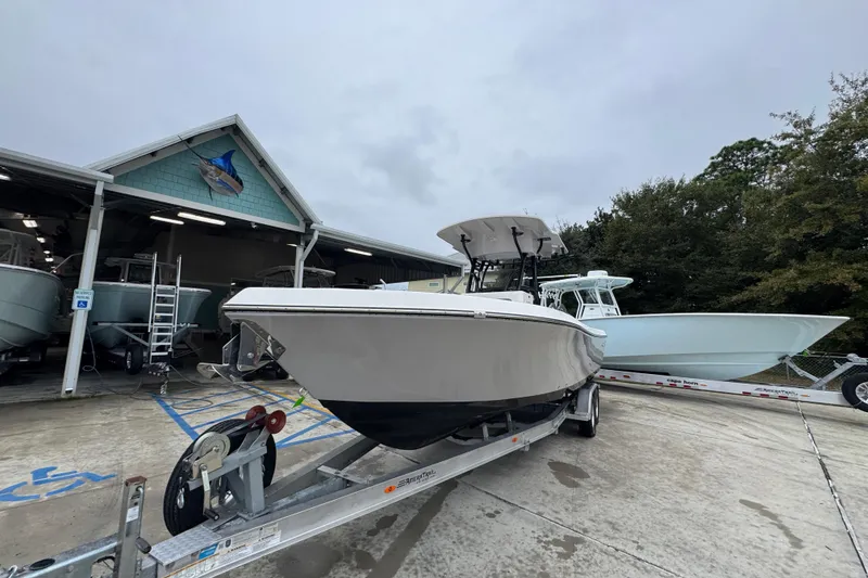 Slide: The Image of 2026 Sea Born LX26 Center Console boat on trailer at marina. - 4