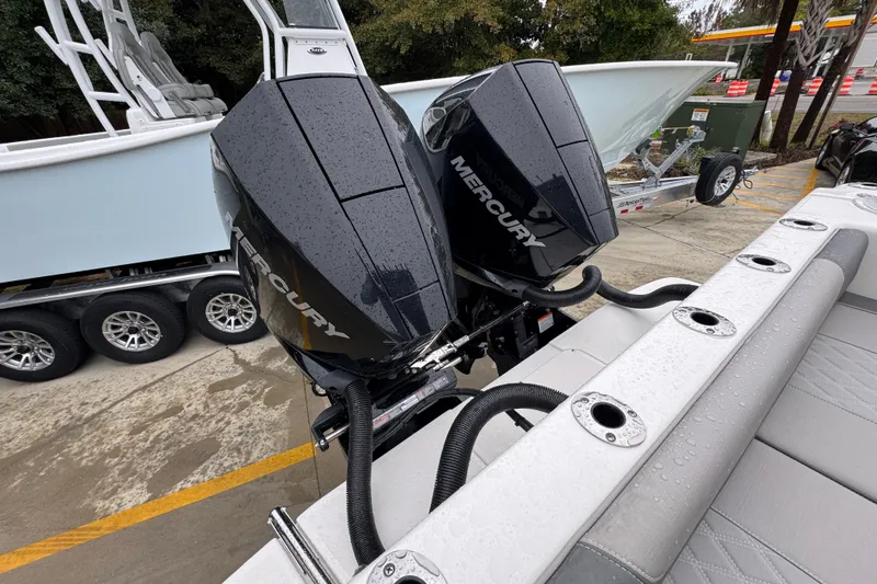 Slide: The Image of 2026 Sea Born LX26 Center Console with dual Mercury outboard engines, parked on a trailer. - 40