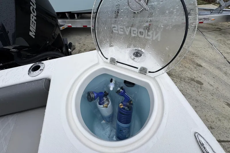 Slide: The Image of 2026 Sea Born LX26 Center Console boat with open storage compartment and marine equipment. - 41