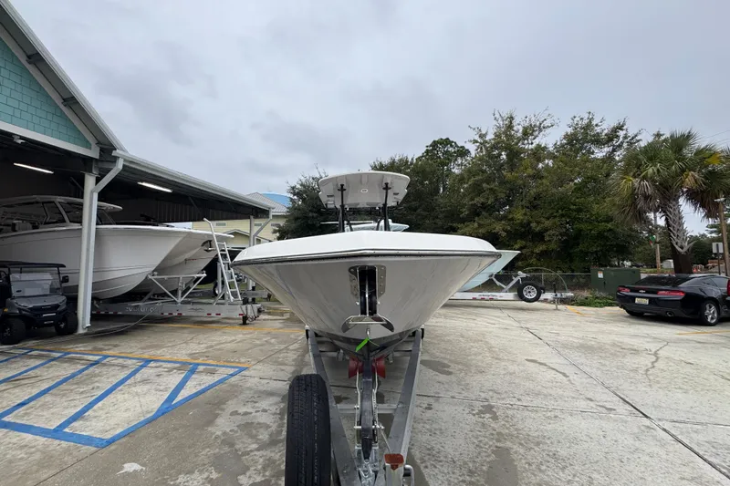 Slide: The Image of 2026 Sea Born LX26 Center Console boat on trailer in marina parking lot. - 6