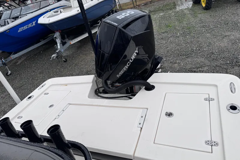 Slide: The Image of 2021 Sea Born FX22 Bay boat with Mercury outboard motor, parked on gravel. - 14