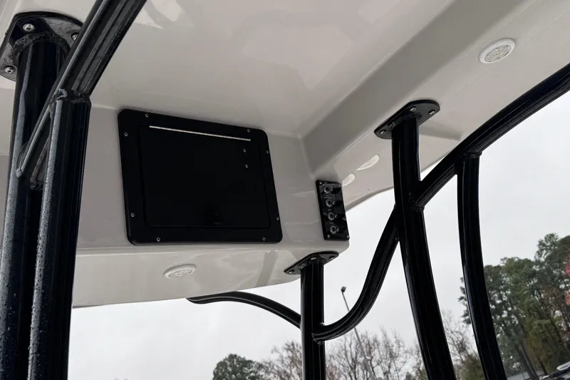 Slide: The Image of 2021 Sea Born FX22 Bay boat T-top with black support poles and control panel. - 15