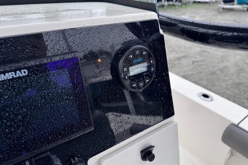 Slide: The Image of 2021 Sea Born FX22 Bay boat dashboard with Simrad display and audio controls. - 18