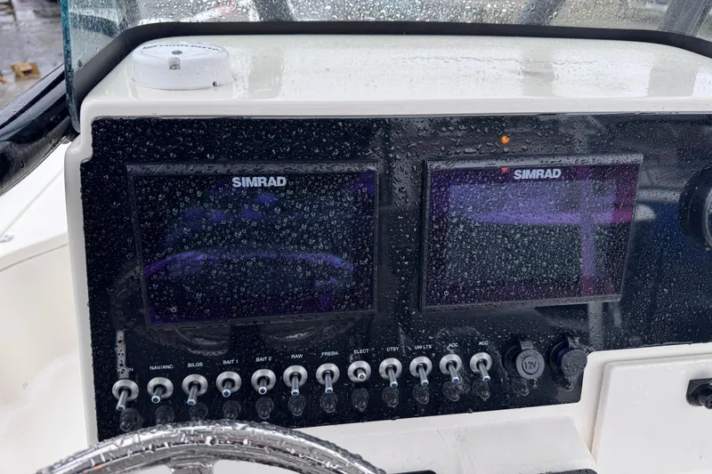 Slide: The Image of Dashboard of 2021 Sea Born FX22 Bay boat with Simrad displays and controls. - 19