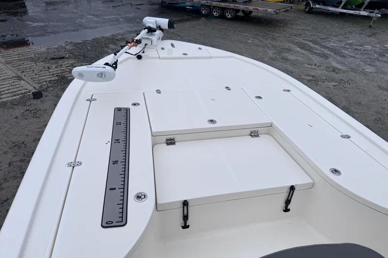 Slide: The Image of 2021 Sea Born FX22 Bay boat deck with storage compartments and measuring ruler. - 21