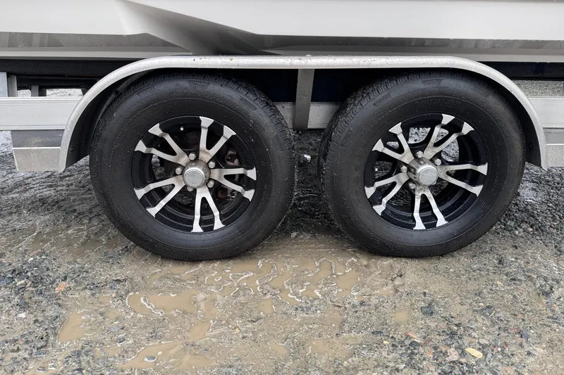 Slide: The Image of Trailer wheels of a 2021 Sea Born FX22 Bay boat on muddy ground. - 24