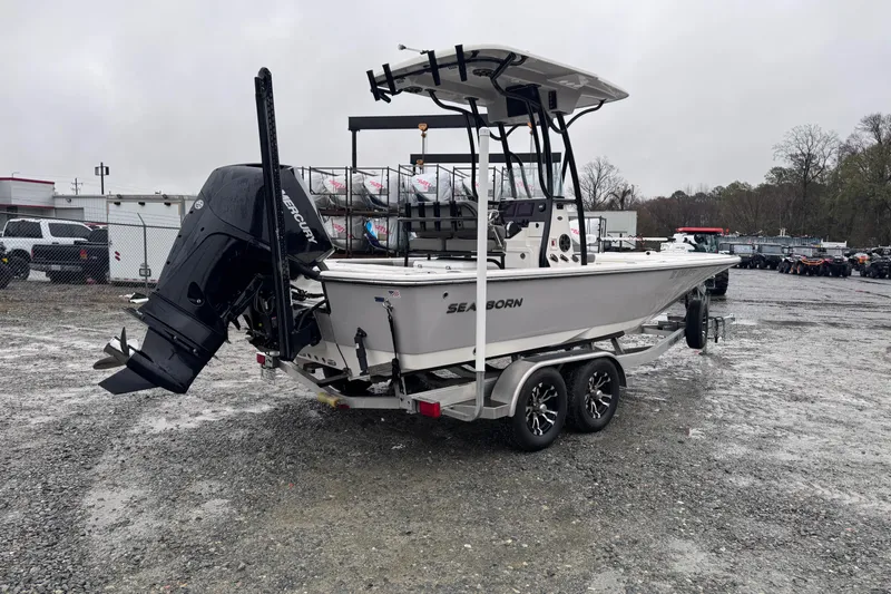 Slide: The Image of 2021 Sea Born FX22 Bay boat on trailer, parked in a gravel lot. - 3