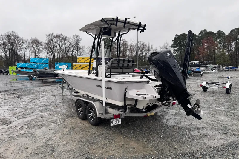Slide: The Image of 2021 Sea Born FX22 Bay boat on trailer in a wet, gravel lot. - 5