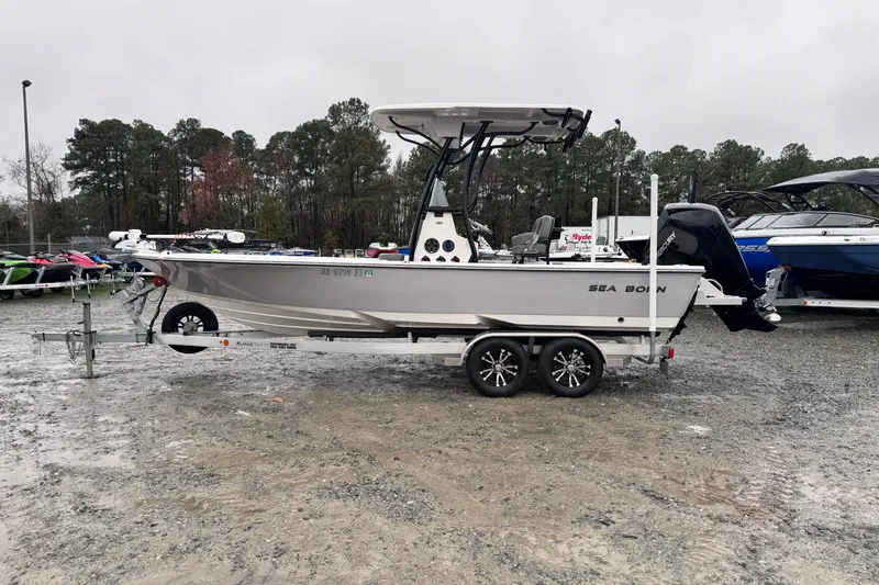 Slide: The Image of 2021 Sea Born FX22 Bay boat on trailer in outdoor setting. - 6