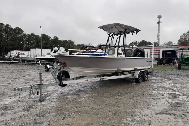 Slide: The Image of 2021 Sea Born FX22 Bay boat on trailer in a parking lot. - 7