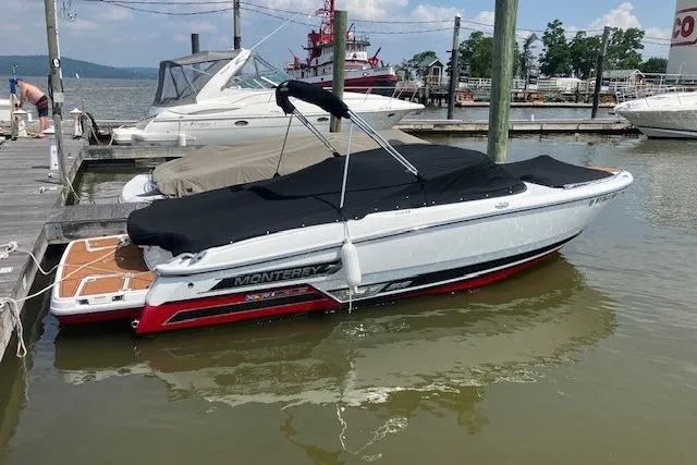 Slide: The Image of 2020 Monterey 238SS Super Sport boat docked at a marina, covered and ready for use. - 7