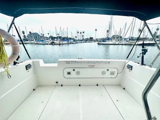 Slide: The Image of 1994 Bayliner 2858 Ciera Command Bridge in marina with sailboats. - 10