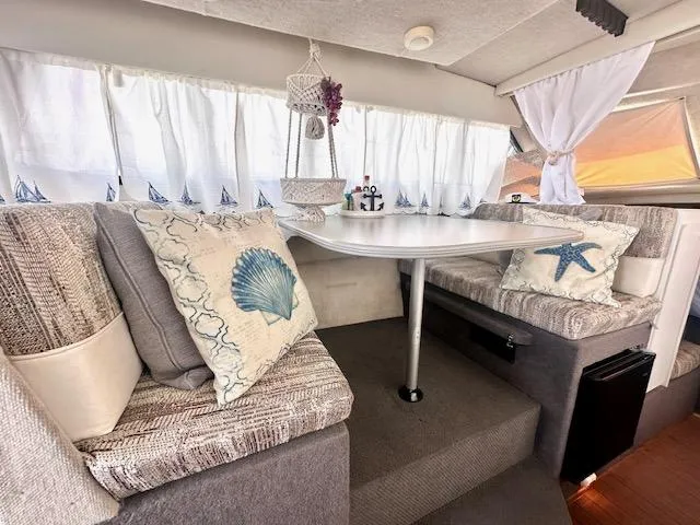 Slide: The Image of Interior of 1994 Bayliner 2858 Ciera Command Bridge with nautical-themed cushions. - 17