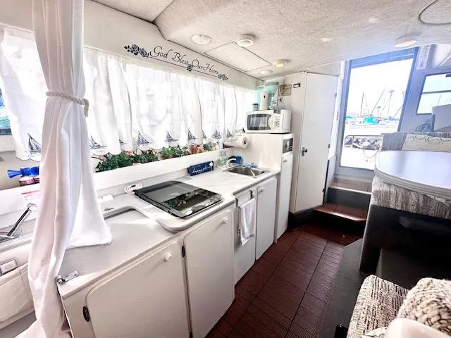 Slide: The Image of Interior of 1994 Bayliner 2858 Ciera Command Bridge with kitchen and dining area. - 18