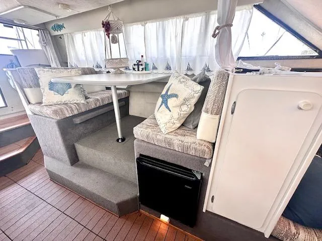 Slide: The Image of Interior of 1994 Bayliner 2858 Ciera Command Bridge with cozy seating area. - 26