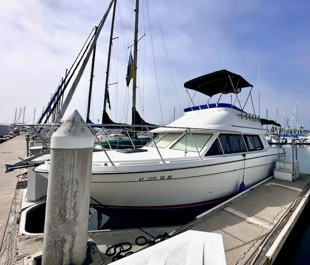 Slide: The Image of 1994 Bayliner 2858 Ciera Command Bridge docked at marina. - 6