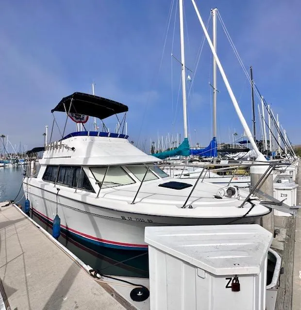 Slide: The Image of 1994 Bayliner 2858 Ciera Command Bridge docked at marina. - 7