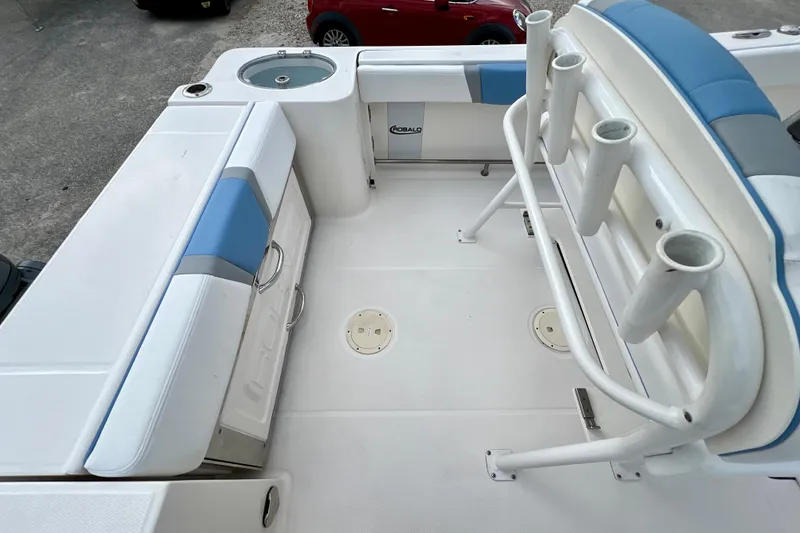 Slide: The Image of 2024 Robalo R230 Center Console boat interior with seating and rod holders. - 11