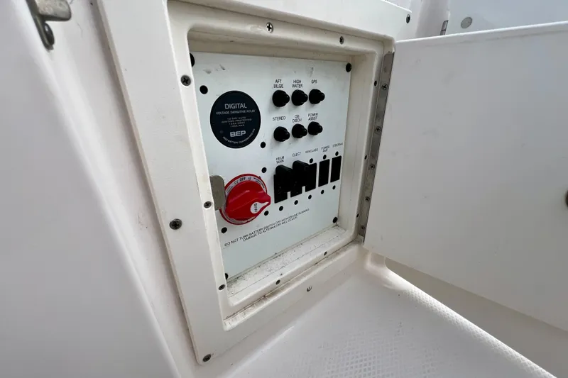 Slide: The Image of 2024 Robalo R230 Center Console boat control panel with switches and digital display. - 14