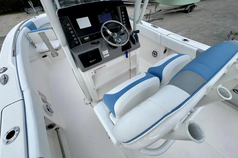 Slide: The Image of 2024 Robalo R230 Center Console boat interior with steering wheel and seating. - 15