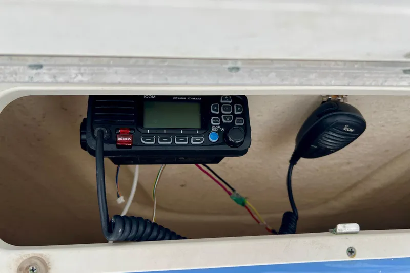 Slide: The Image of VHF marine radio in 2024 Robalo R230 Center Console boat compartment. - 19