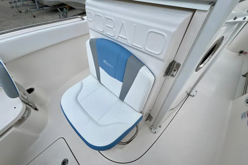 Slide: The Image of 2024 Robalo R230 Center Console boat seat, white and blue design. - 22