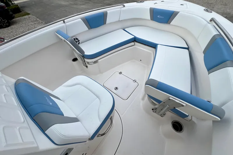 Slide: The Image of 2024 Robalo R230 Center Console boat with blue and white seating arrangement. - 24