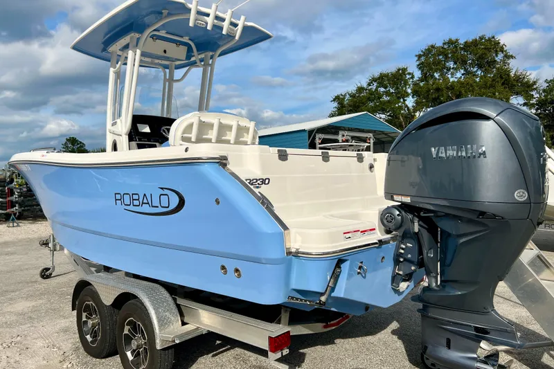 Slide: The Image of 2024 Robalo R230 Center Console boat with Yamaha engine, parked on a trailer. - 6